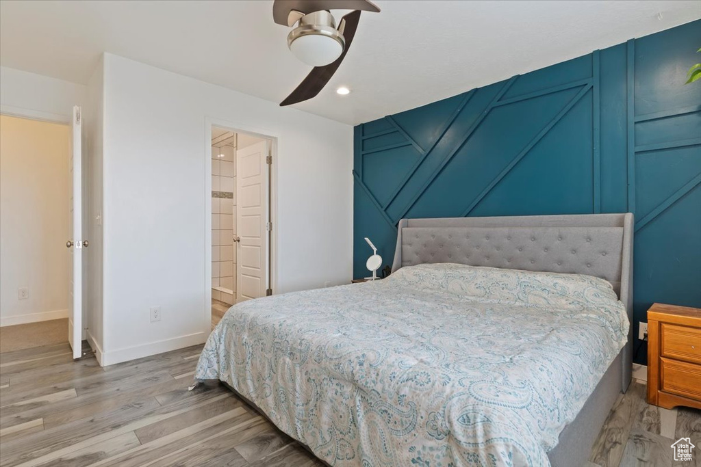 Bedroom featuring light wood-style floors, baseboards, a decorative wall, recessed lighting, and a ceiling fan