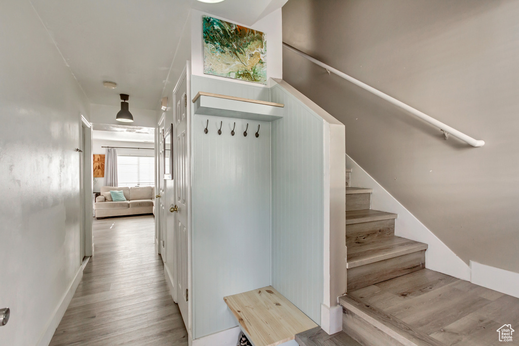 Stairs featuring wood finished floors