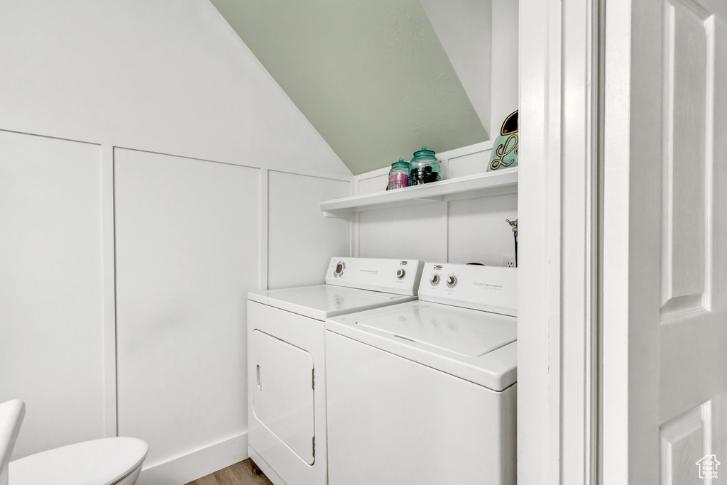 Laundry area featuring washing machine and dryer and light wood-style floors