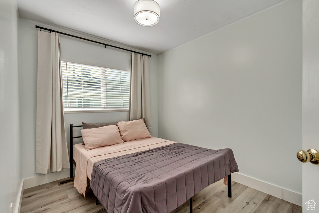 Bedroom featuring light wood-type flooring and baseboards