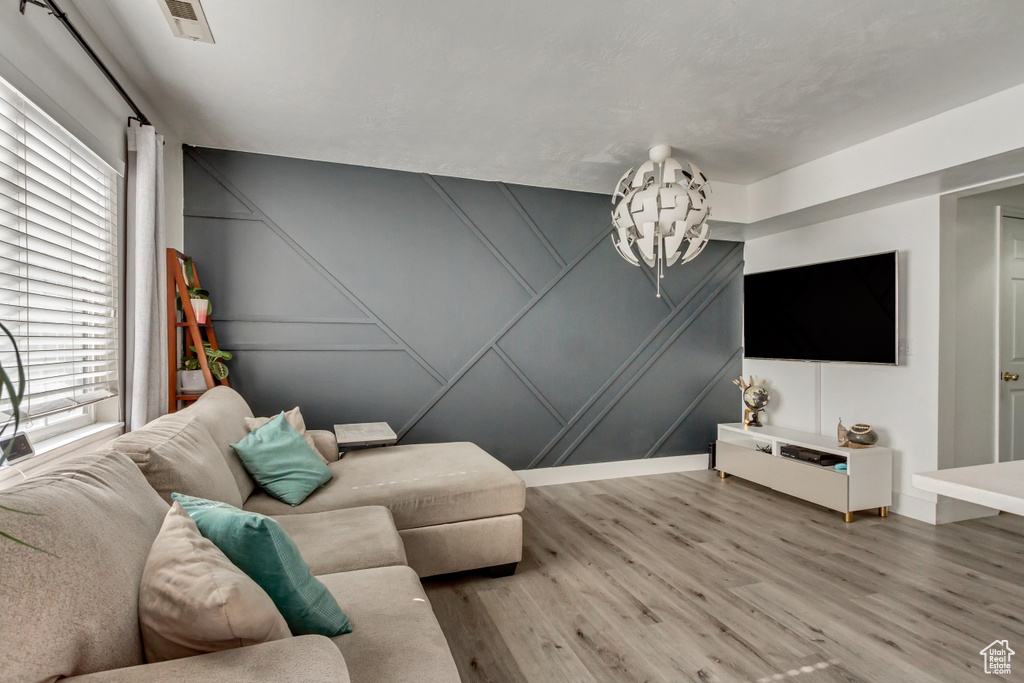 Living room with a decorative wall and wood finished floors