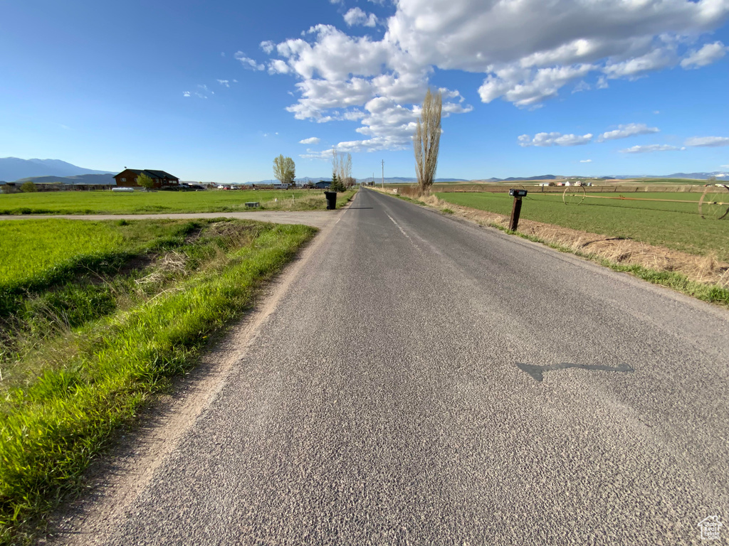 View of asphalt street featuring a view of rural / pastoral area