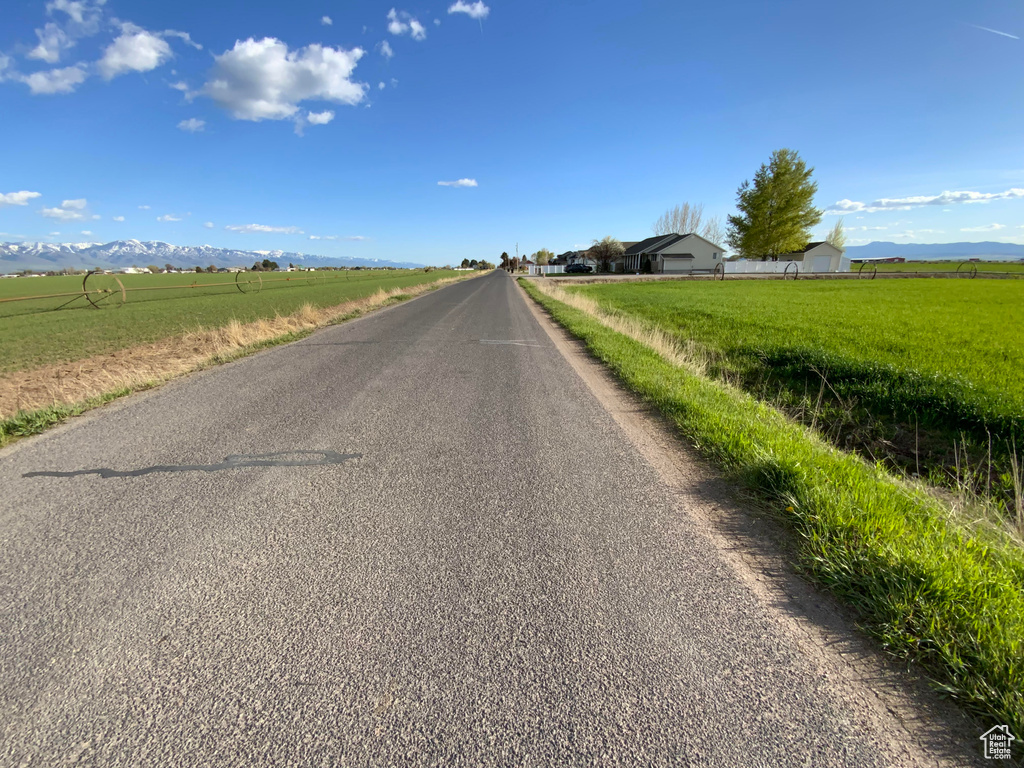 View of asphalt street with a rural view