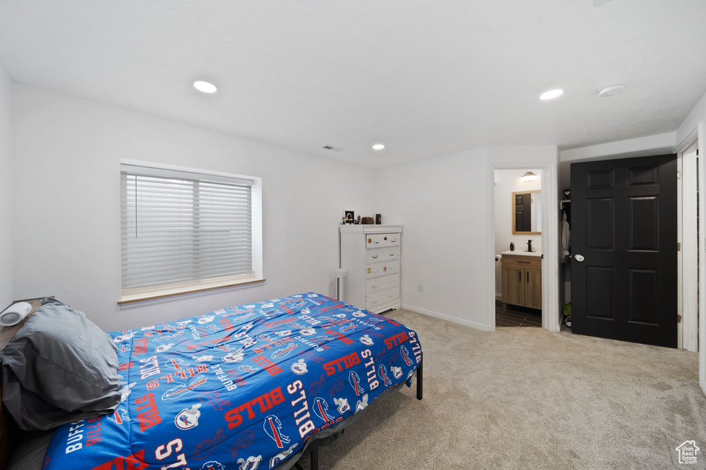 Bedroom featuring carpet floors, recessed lighting, baseboards, and ensuite bath