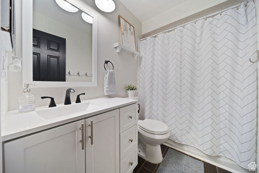 Full bathroom featuring toilet and vanity