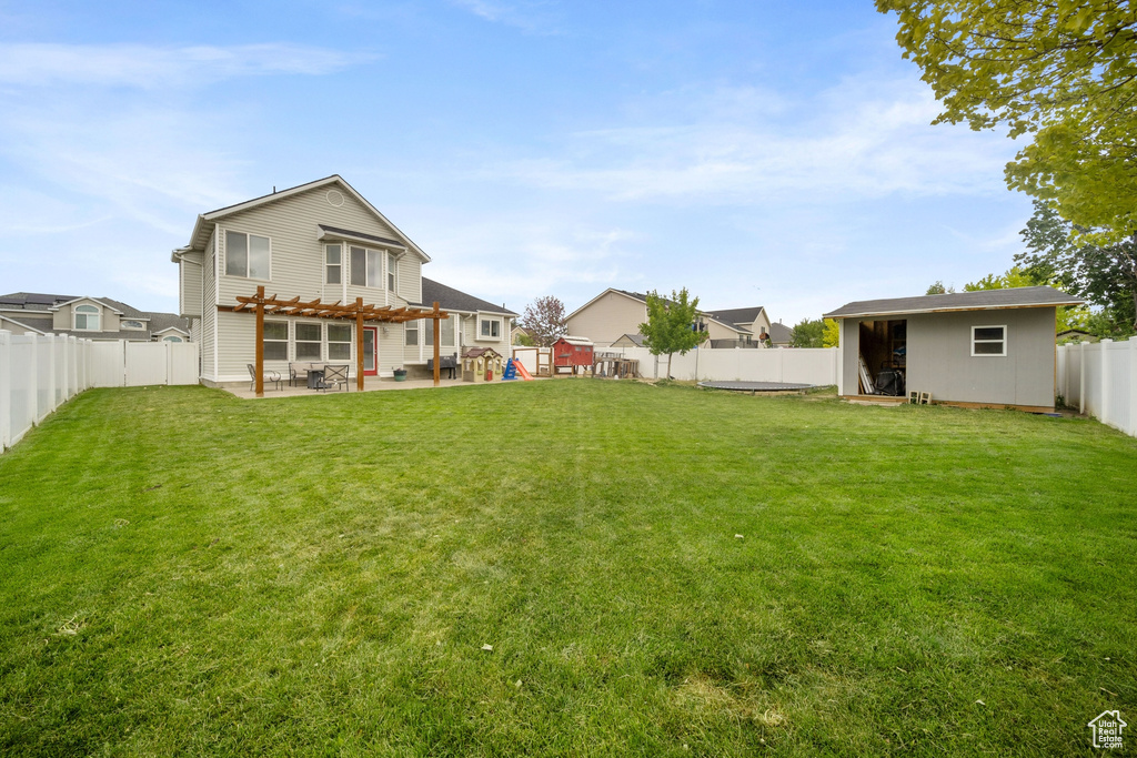 View of yard with a pergola and a patio