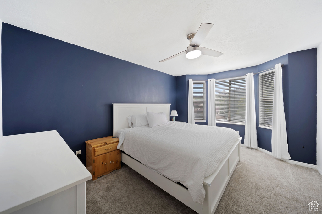 Bedroom with carpet flooring, a ceiling fan, and baseboards