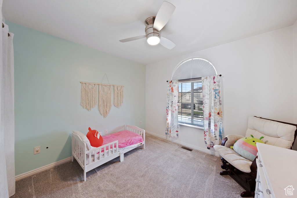 Carpeted bedroom with baseboards and ceiling fan