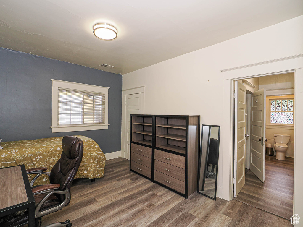 Office area with wood finished floors and healthy amount of natural light