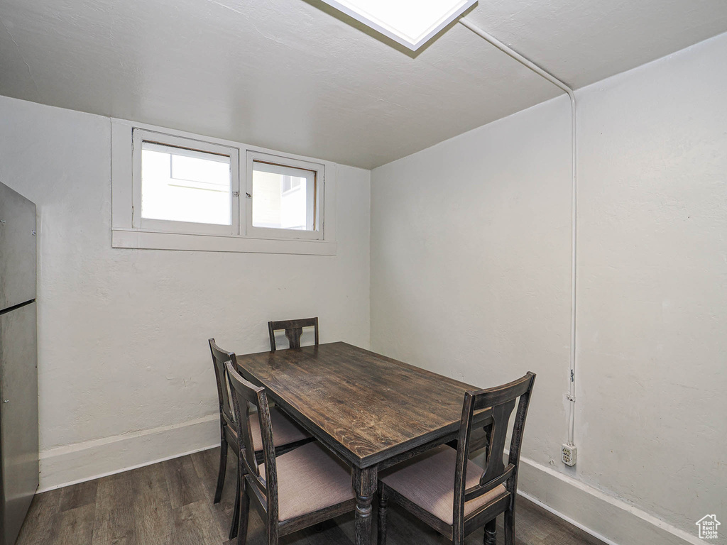 Dining space with wood finished floors and baseboards
