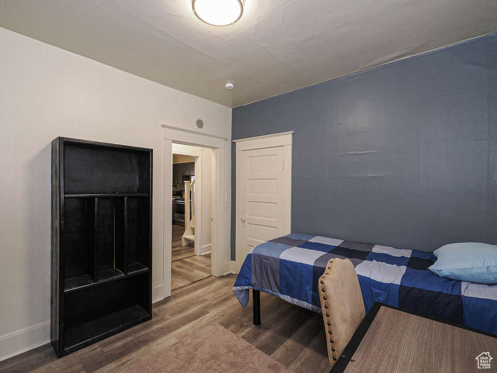 Bedroom featuring wood finished floors and baseboards