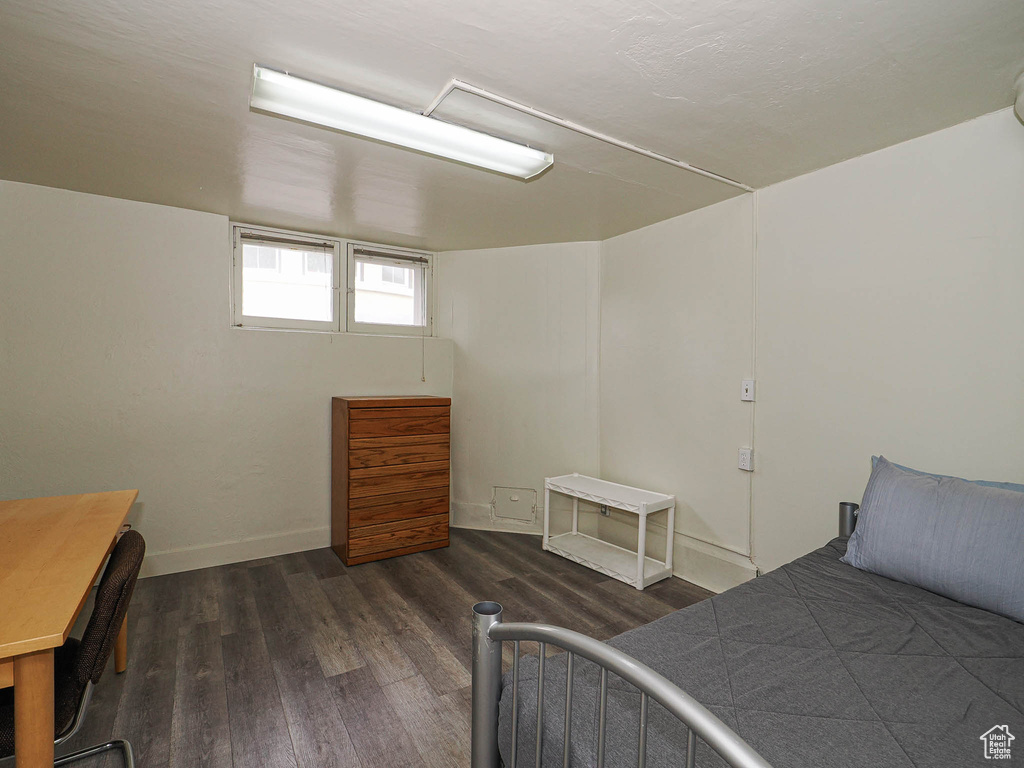 Bedroom with wood finished floors and baseboards