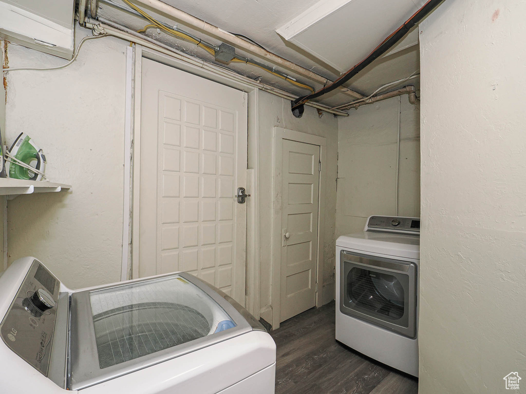 Laundry area featuring dark wood finished floors