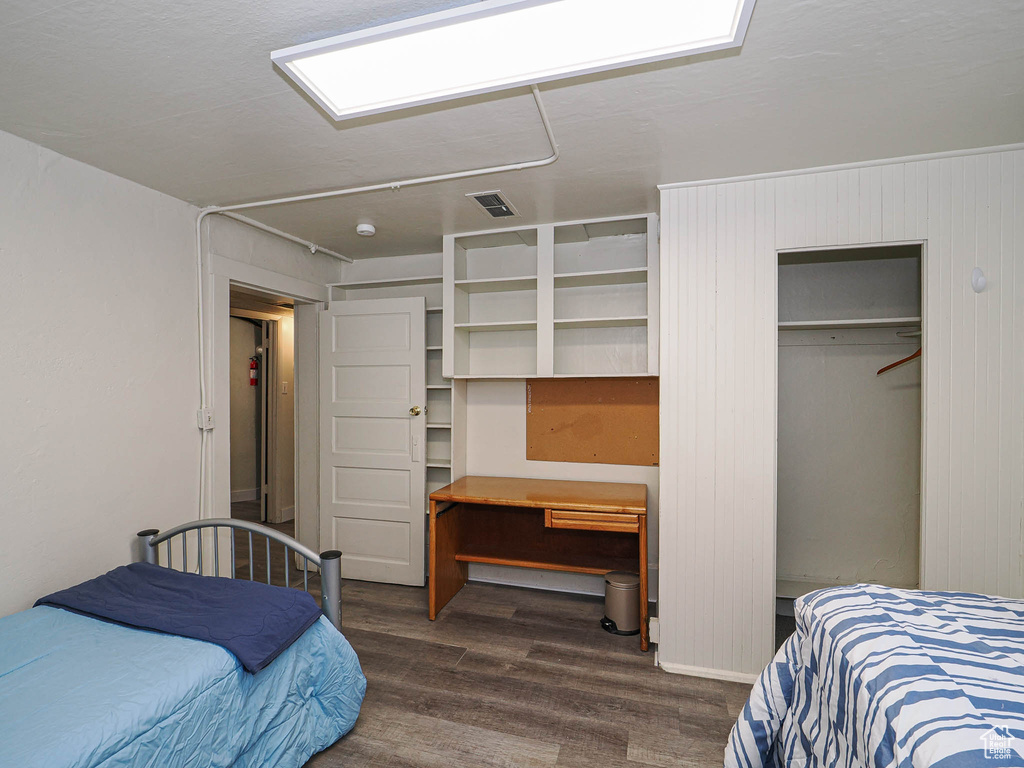 Bedroom with dark wood-style floors
