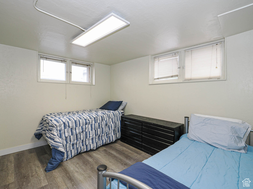 Bedroom featuring wood finished floors and baseboards