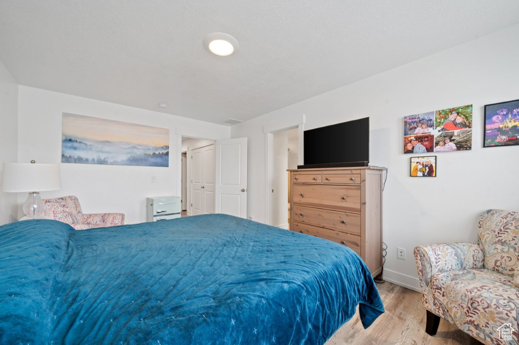 Bedroom featuring wood finished floors and baseboards