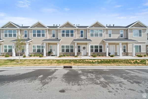 View of property featuring stone siding
