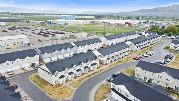 Drone / aerial view of a mountainous background and an industrial area