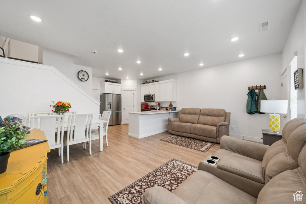Living room featuring light wood-type flooring and recessed lighting