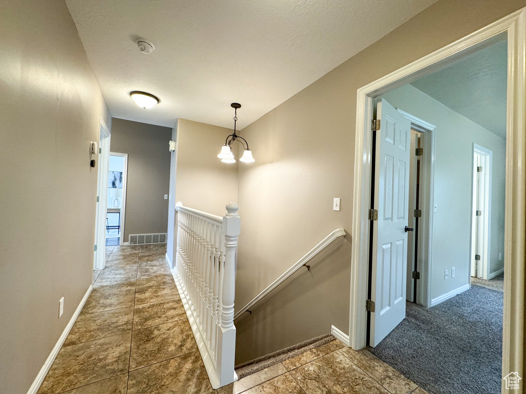 Hall with an upstairs landing and baseboards