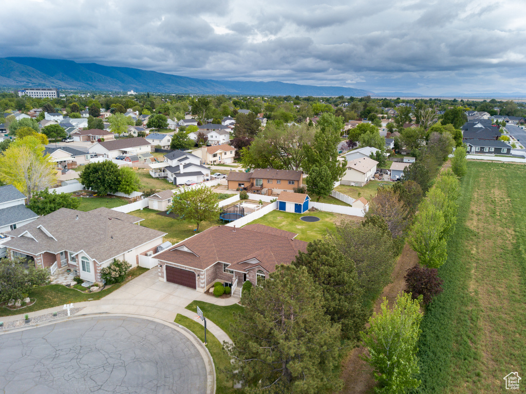 Aerial perspective of suburban area with a mountainous background