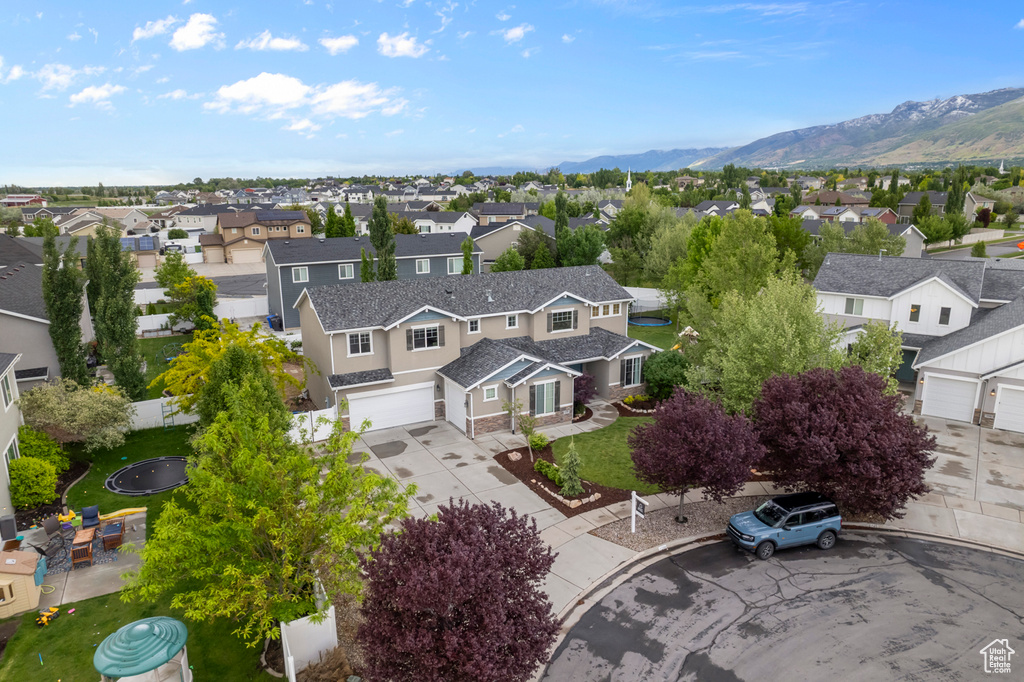 Aerial perspective of suburban area featuring a mountainous background