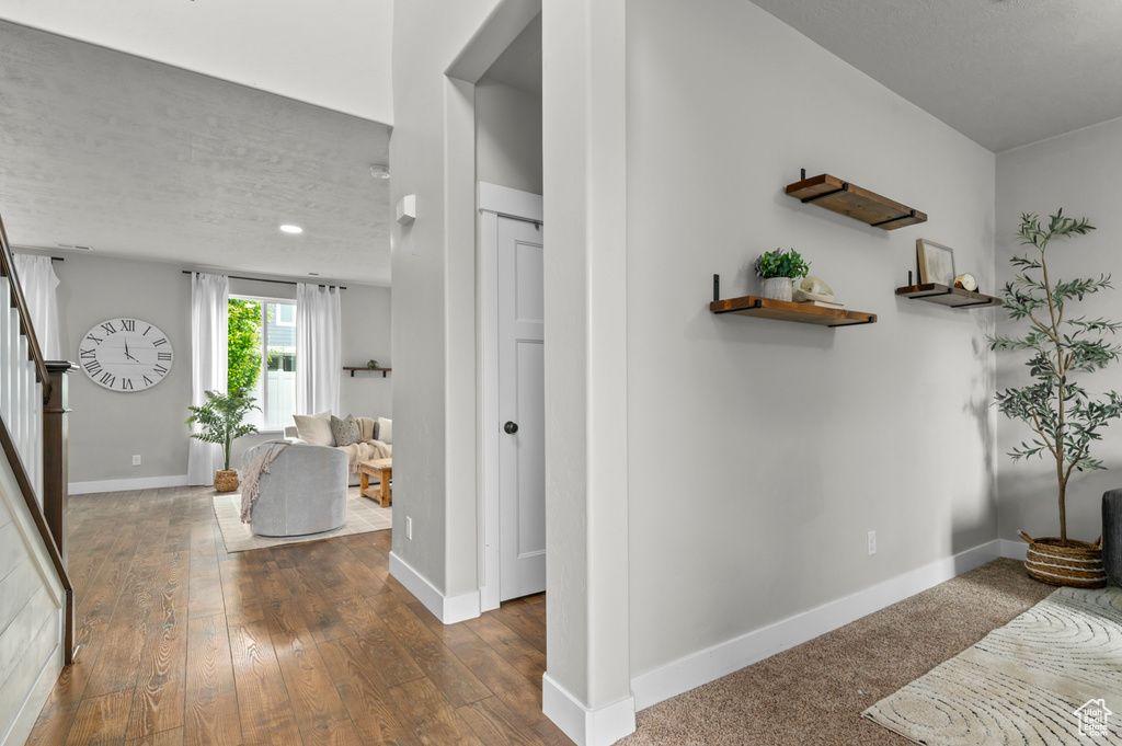 Entrance foyer with stairway, baseboards, dark wood-style flooring, and recessed lighting