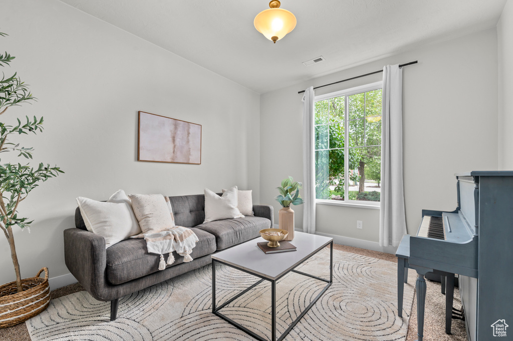 Living room featuring light colored carpet and baseboards