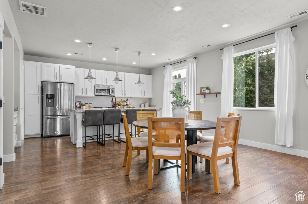 Dining room featuring recessed lighting, dark wood-type flooring, and baseboards