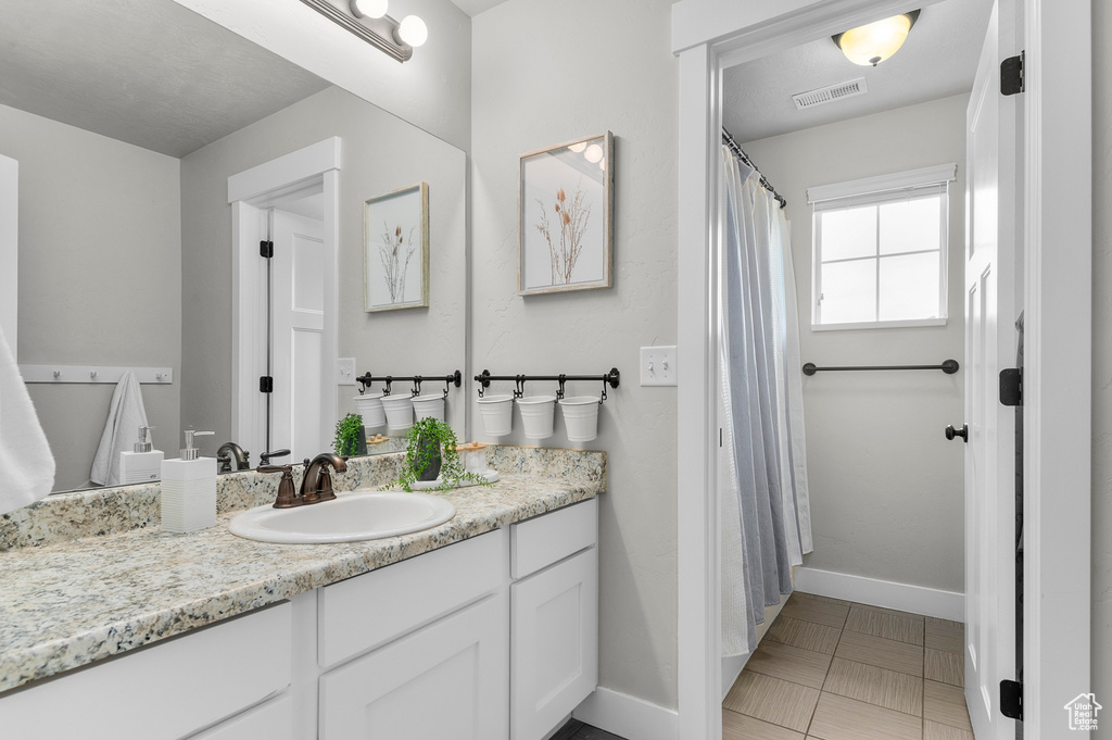Full bathroom featuring baseboards and vanity