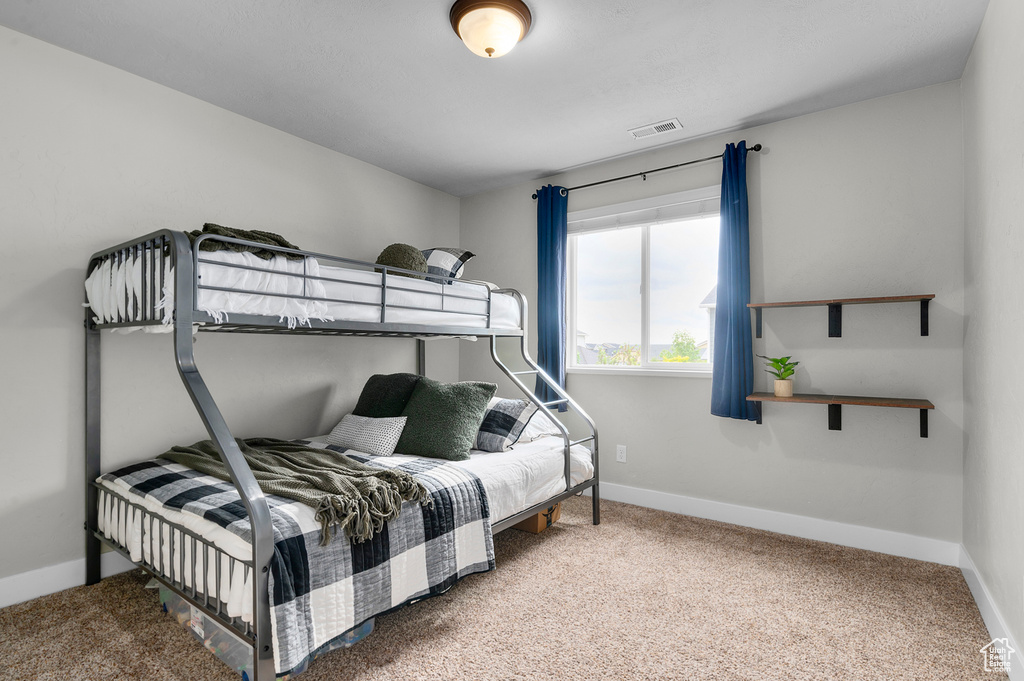 Bedroom with carpet floors and baseboards