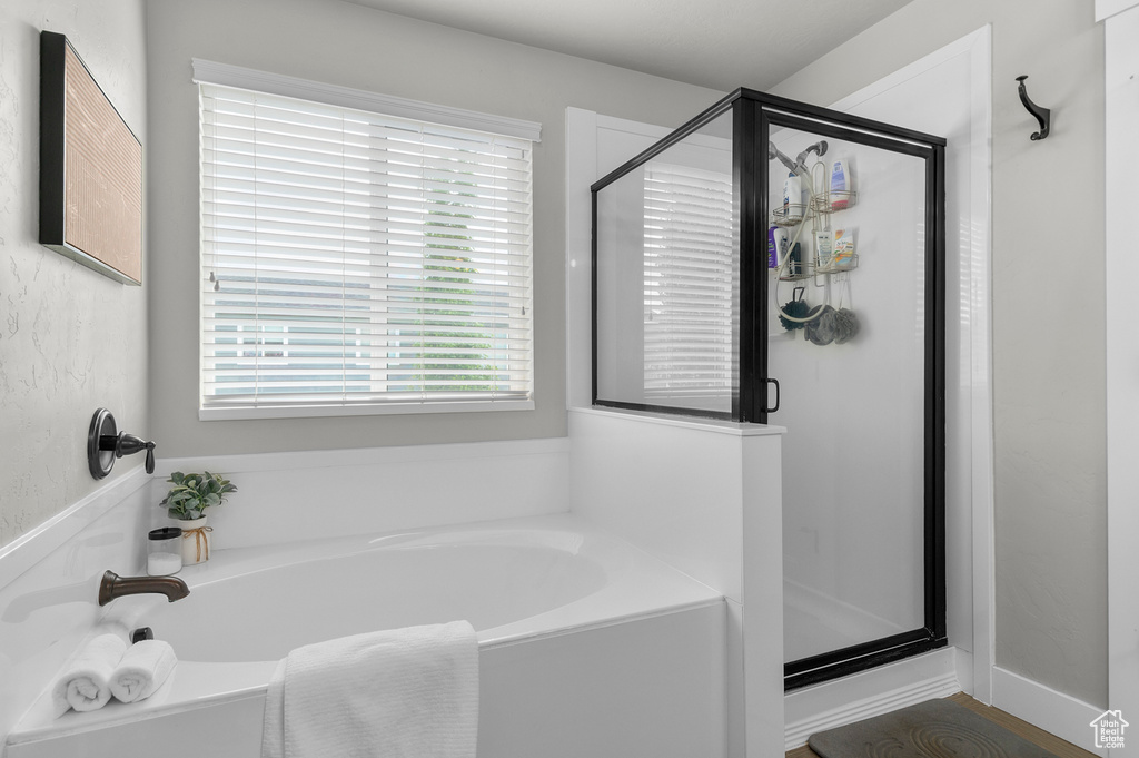 Full bath featuring a garden tub and a stall shower