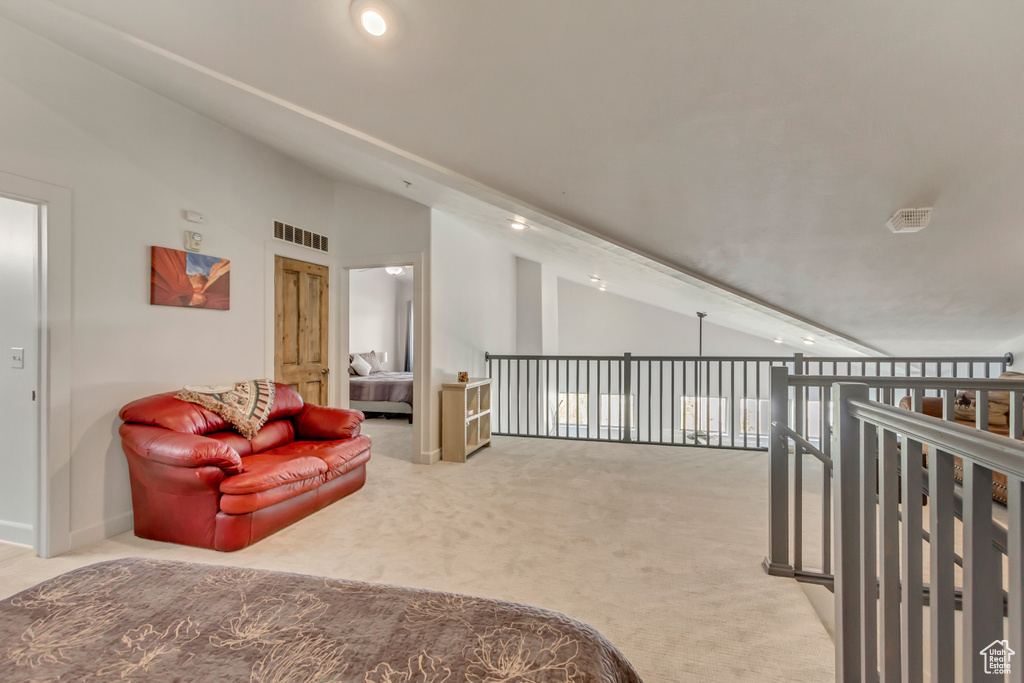 Living area featuring carpet flooring, recessed lighting, vaulted ceiling, and baseboards