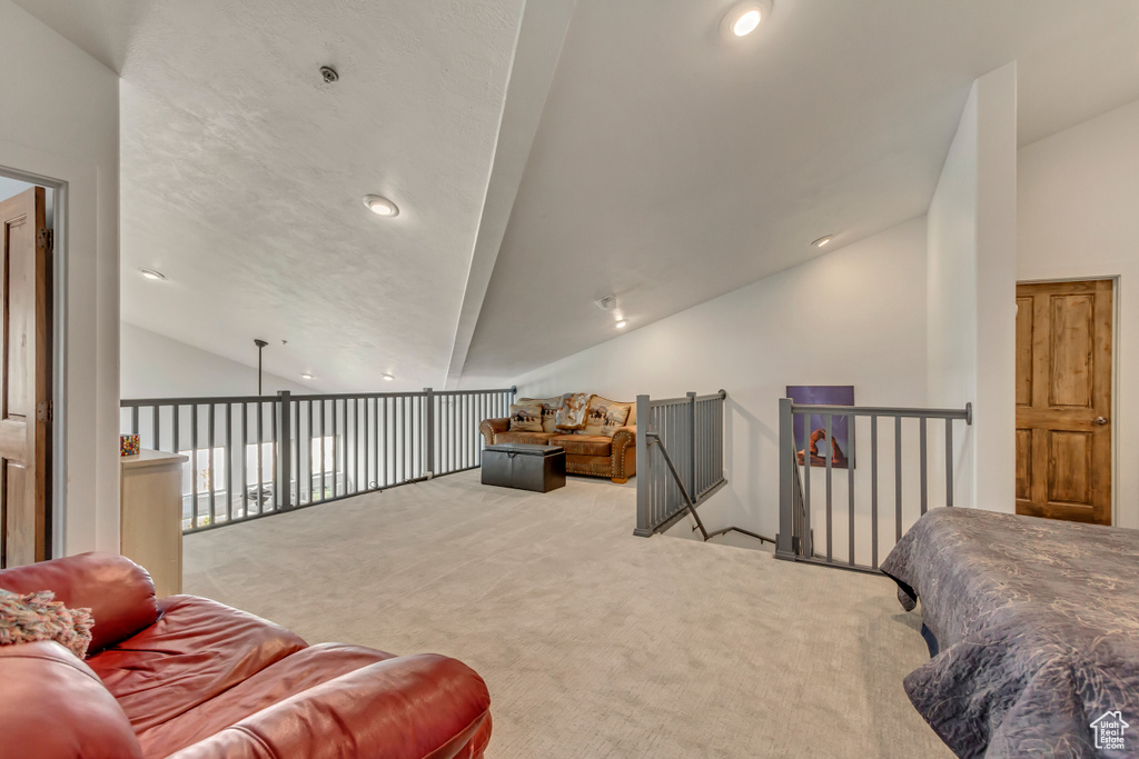 Interior space featuring vaulted ceiling, carpet, and recessed lighting