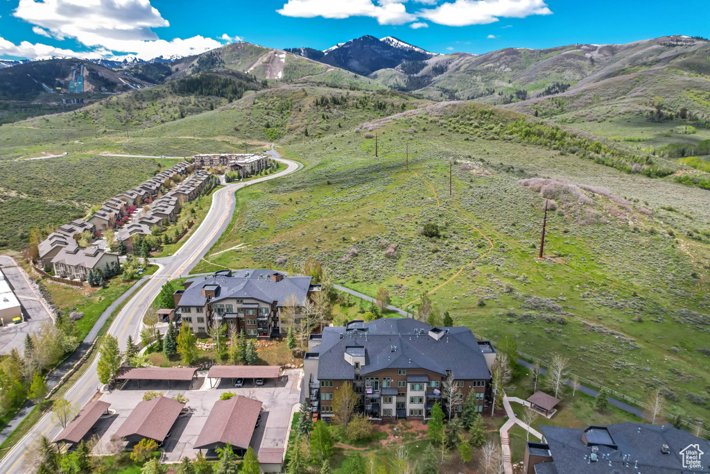 Aerial view of property and surrounding area featuring mountains