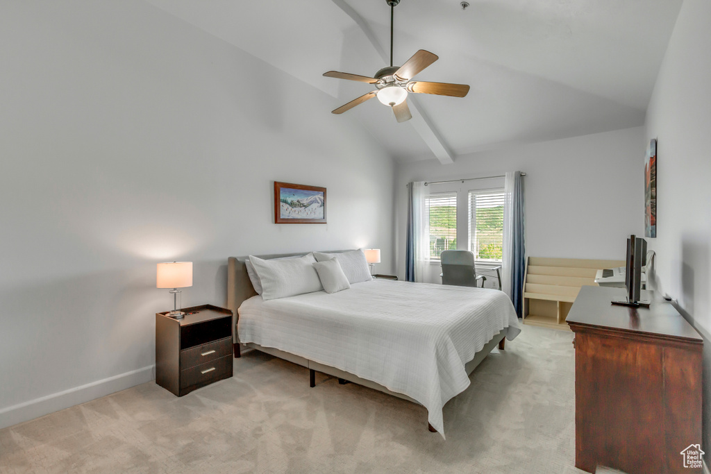 Bedroom with lofted ceiling, light colored carpet, and a ceiling fan