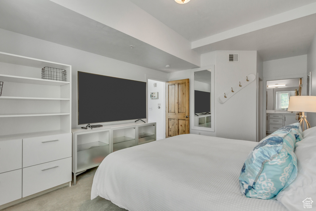 Bedroom featuring light carpet