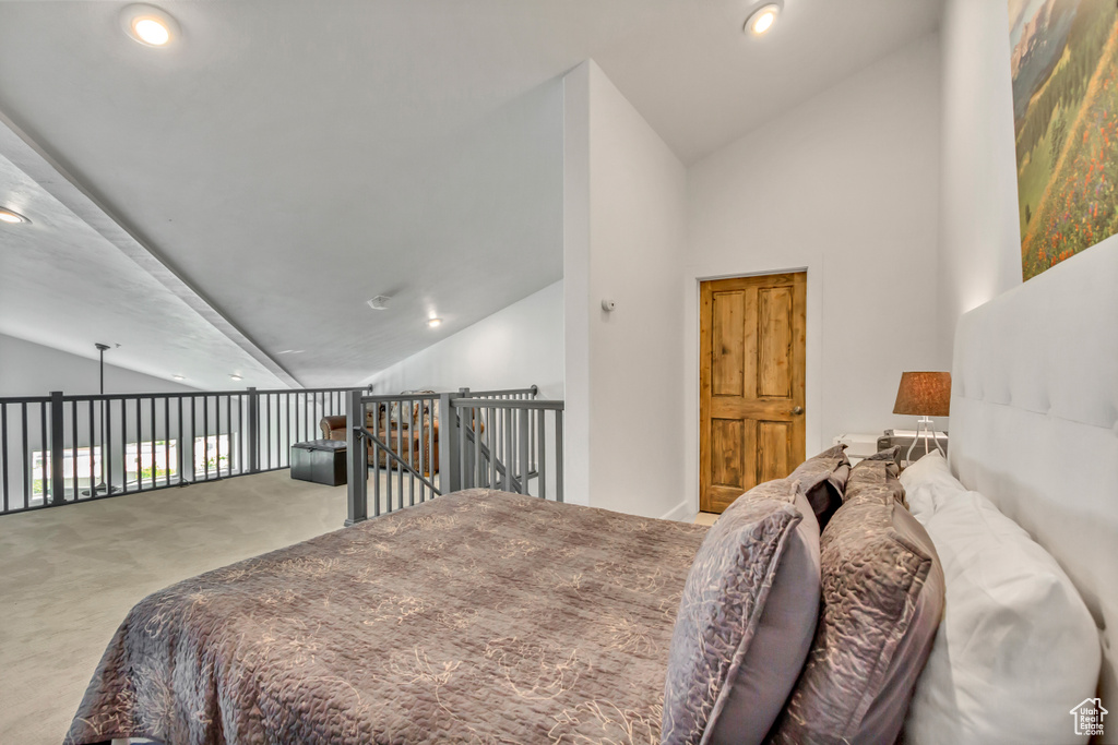 Bedroom with carpet flooring, recessed lighting, and high vaulted ceiling