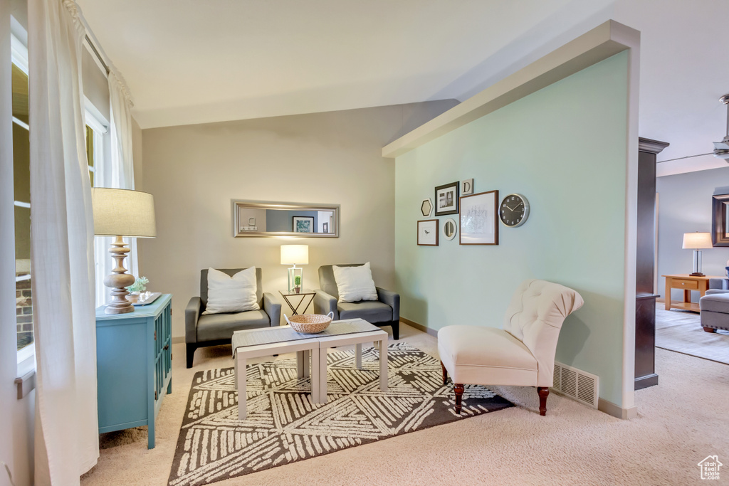 Sitting room with light colored carpet and baseboards