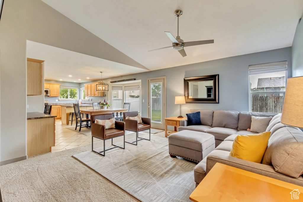Living area featuring lofted ceiling, ceiling fan, and recessed lighting