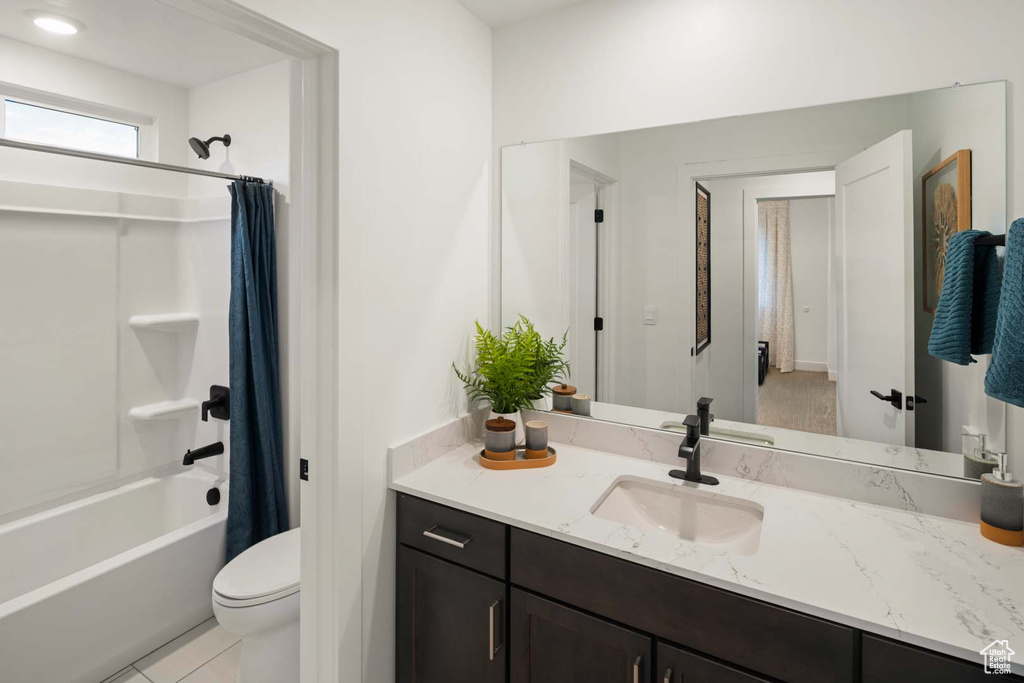 Full bath featuring vanity, shower / bath combo, toilet, and tile patterned floors