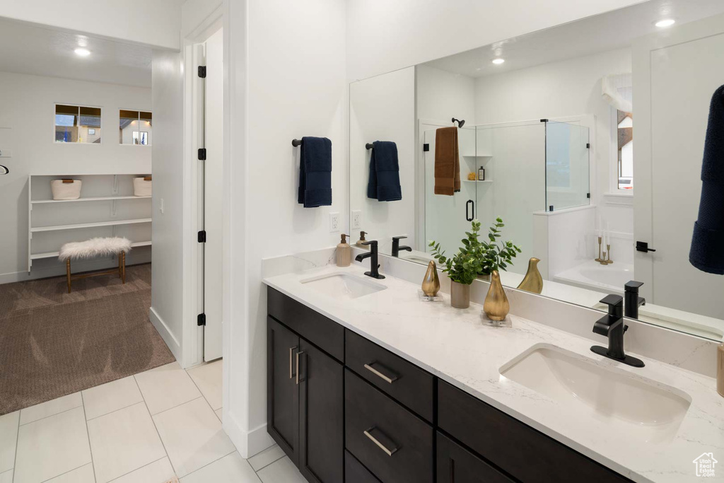Full bathroom with a shower stall, double vanity, recessed lighting, a bath, and tile patterned flooring