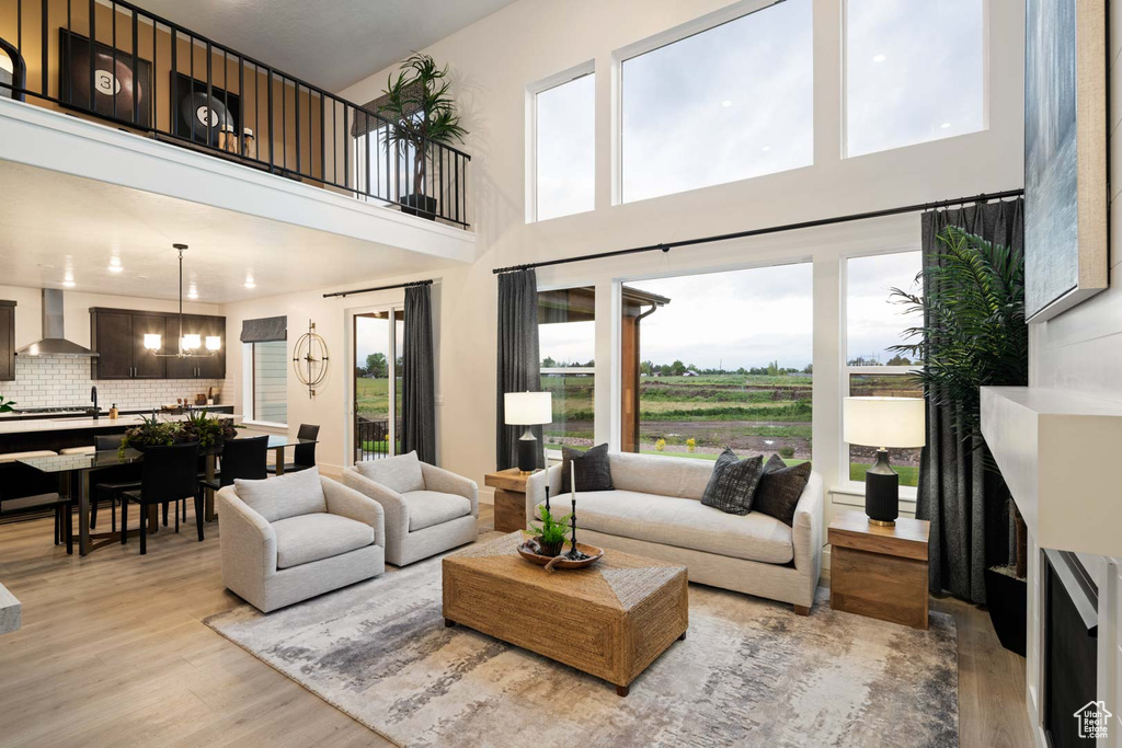 Living room featuring light wood finished floors and a high ceiling