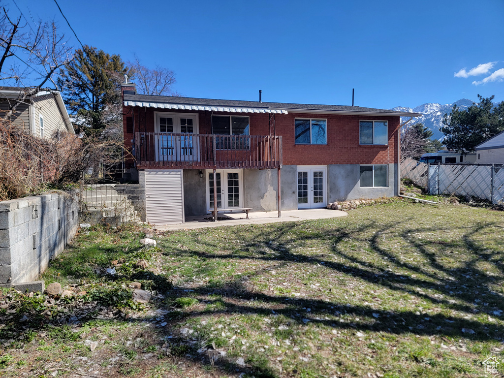 Rear view of property with french doors, a patio, and a wooden deck