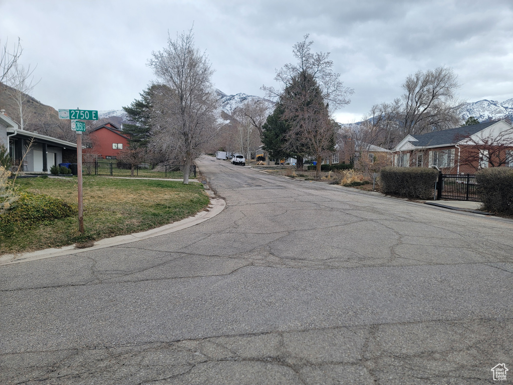 View of asphalt road featuring a residential view
