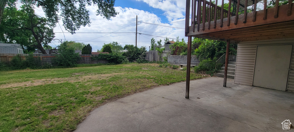 View of yard with a patio and stairway