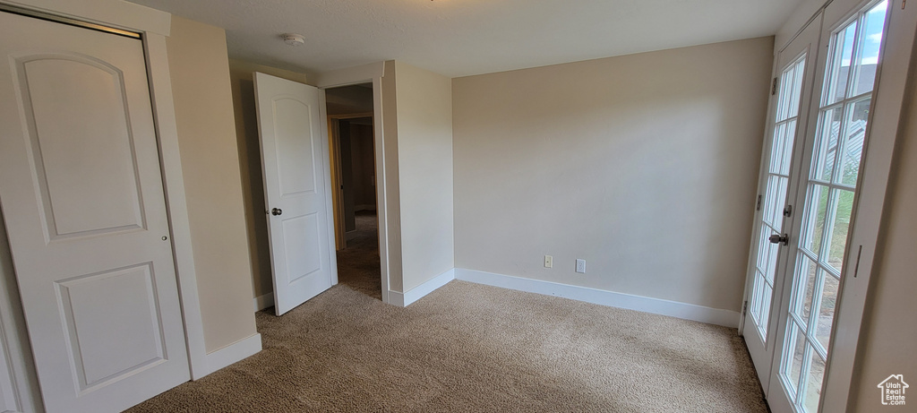 Unfurnished bedroom with carpet and baseboards