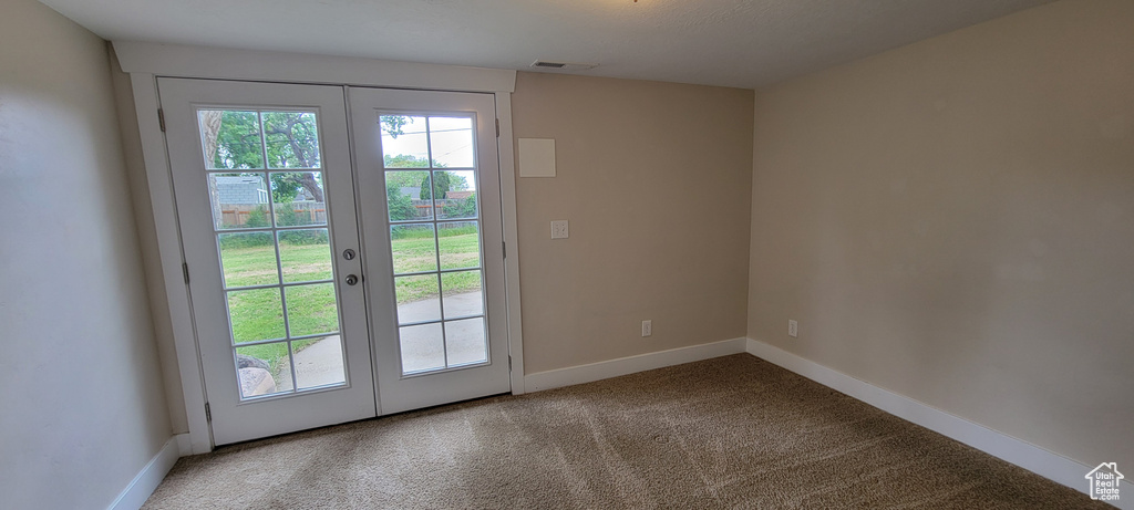 Doorway to outside featuring french doors, carpet flooring, and baseboards
