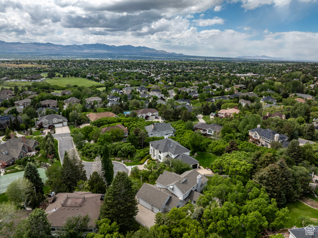 Aerial perspective of suburban area featuring a mountainous background