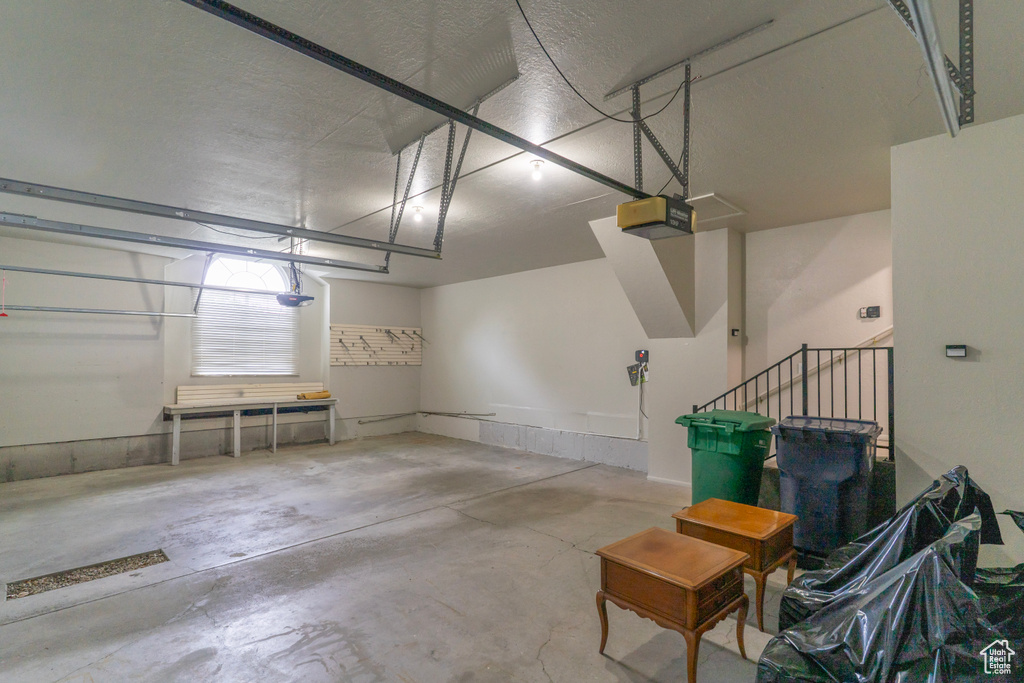 Garage featuring a garage door opener